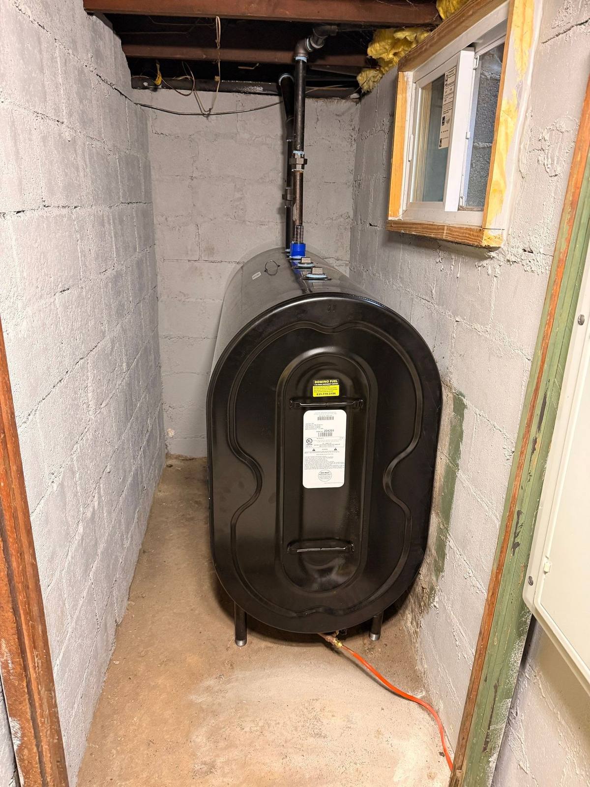Oil tank in a tight Levittown basement corner before removal