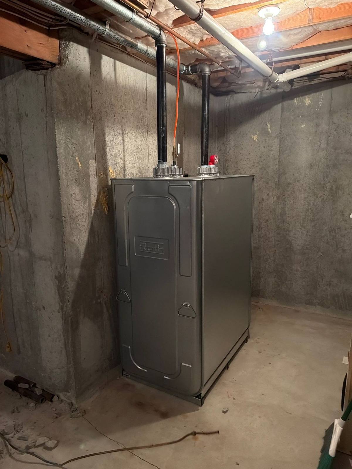 Unfinished Nassau County basement with new oil tank set after old tank removal