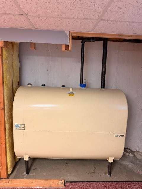 Unused heating oil tank left behind after a heating conversion in a Levittown basement